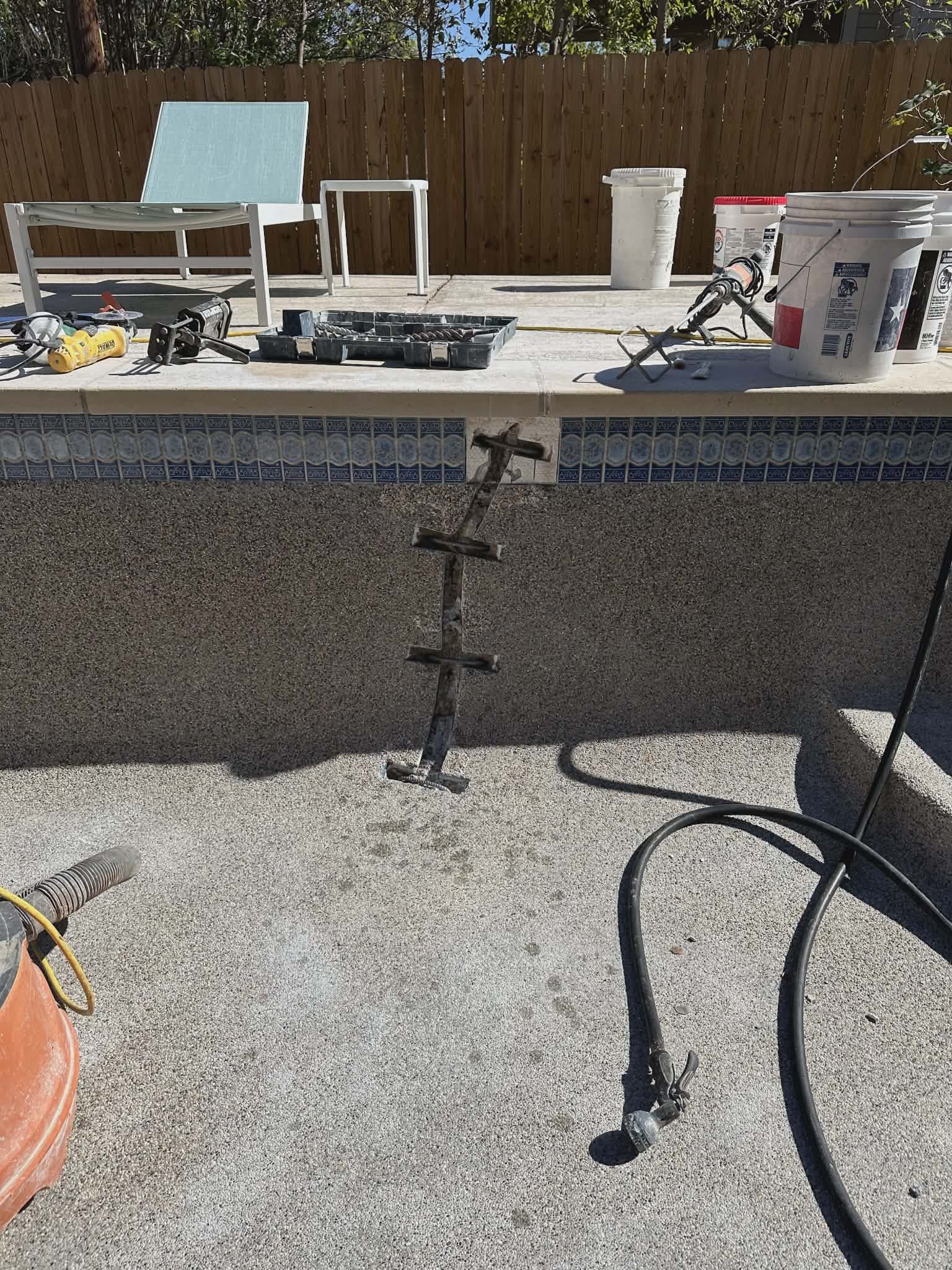 Pool crack repair - technician sealing a wall crack